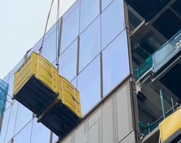 A crane-able Porta King unit being lifted onto a high-rise deck